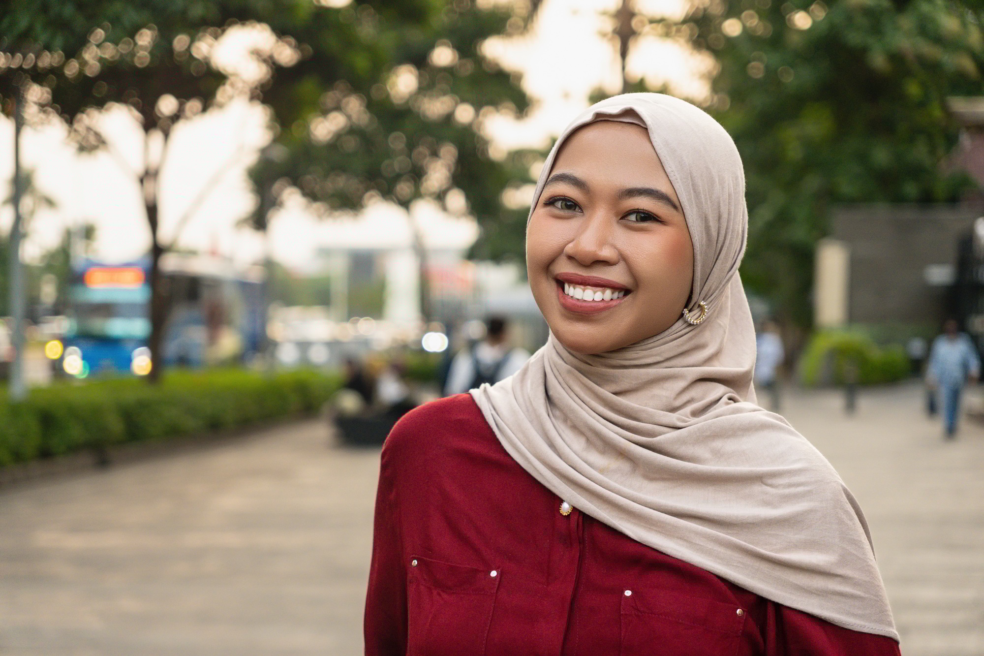 Beautiful young Indonesian woman smiling looking to camera confident and happy